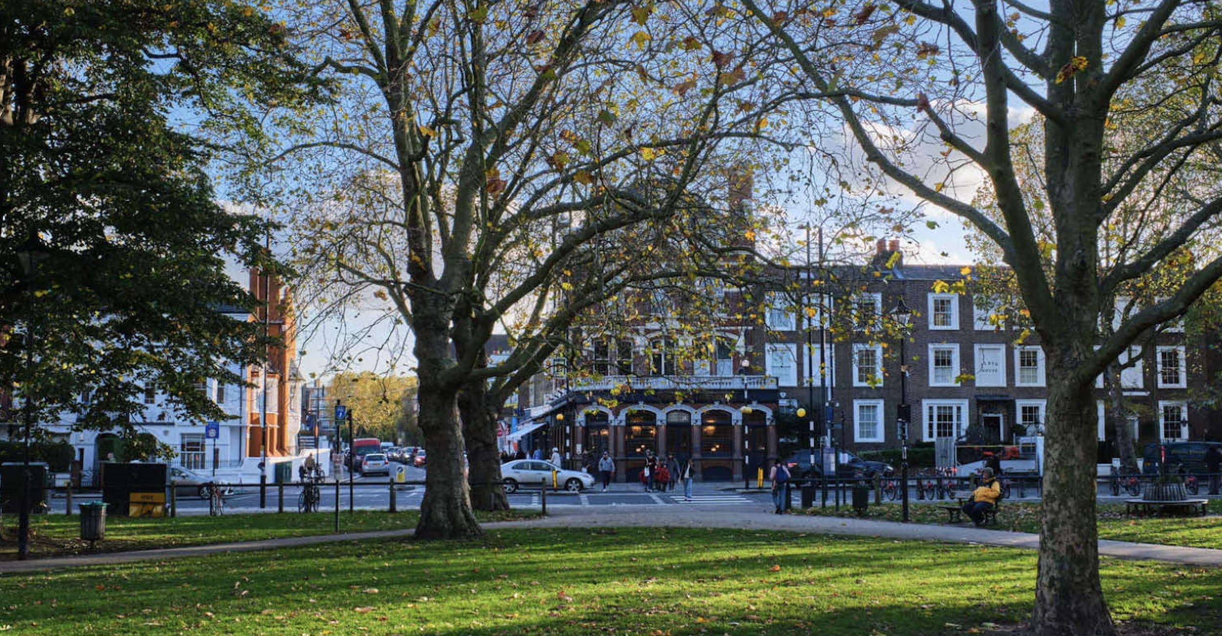 Parsons Green urban park scene with trees, green lawn, and traditional British architecture